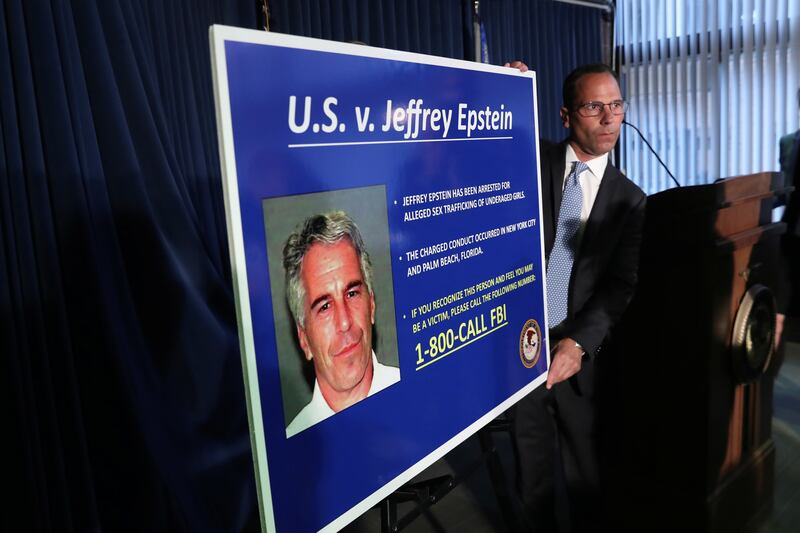 An employee of the Southern District of New York prepares a poster detailing the charges against Jeffrey Epstein—sex trafficking of minors and conspiracy to commit sex trafficking of minors—following his arrest in New York City on July 8, 2019.