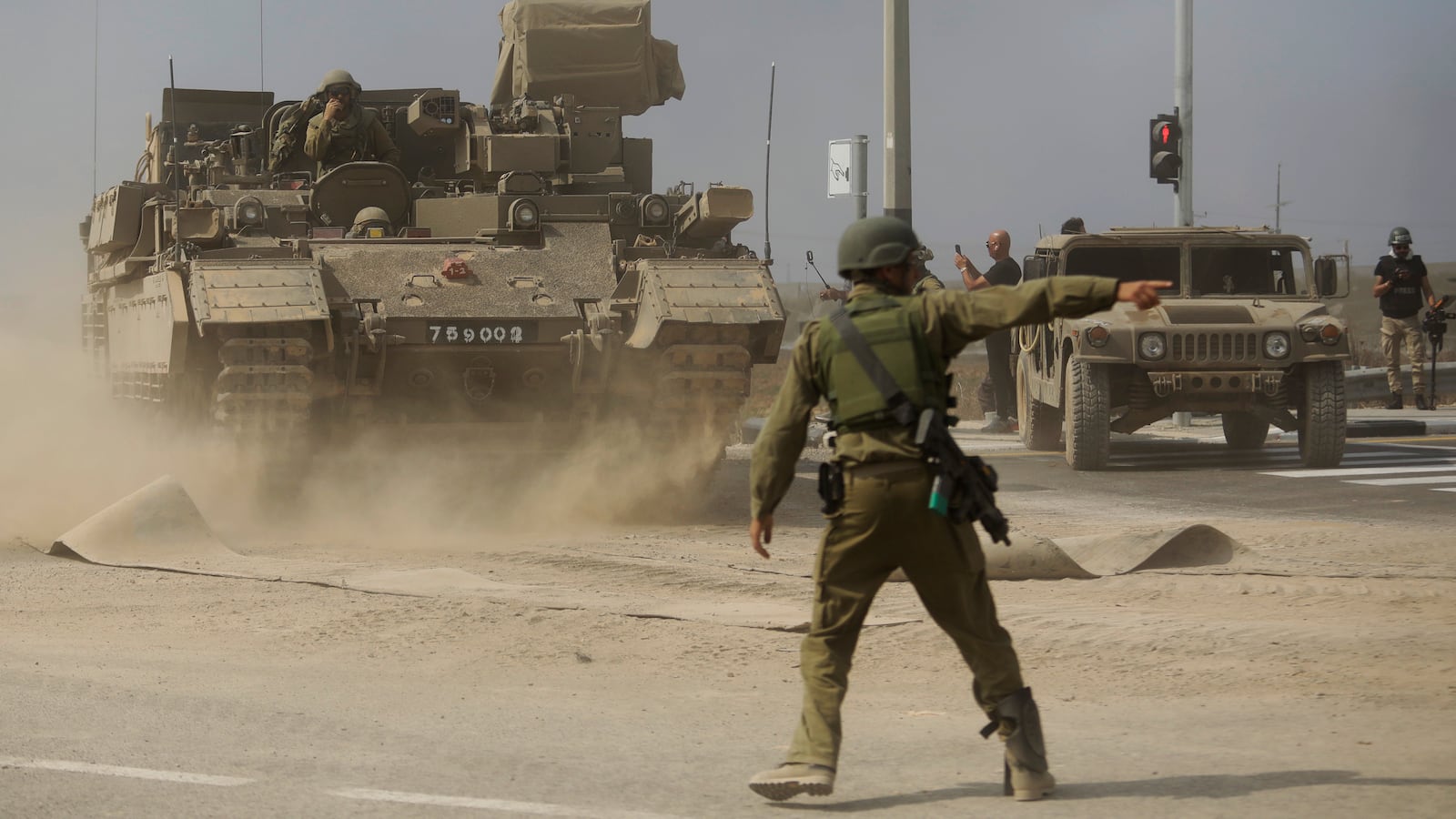 An Israeli soldier gives directions to a tank unit near the border with Gaza.