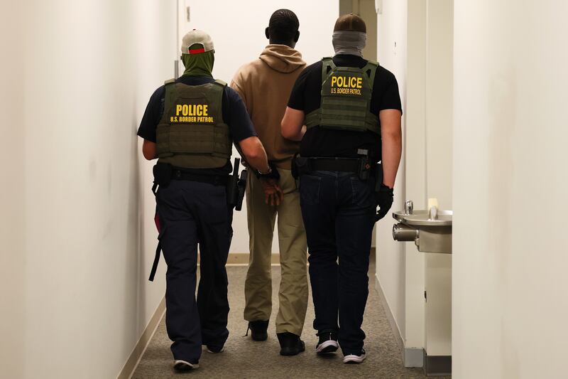 Federal agents detain a man after his court hearing in immigration court at the Ted Weiss Federal Building on July 09, 2025 in New York City.