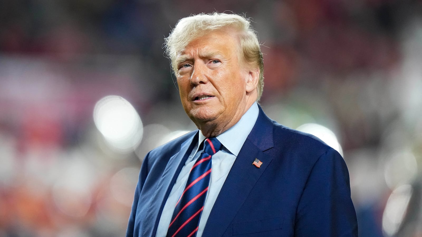 Former President Donald Trump looks on at half time of a game between the South Carolina Gamecocks and the Clemson Tigers at Williams-Brice Stadium.