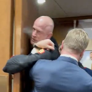 Sheehy goes to help police drag McGinnis out.