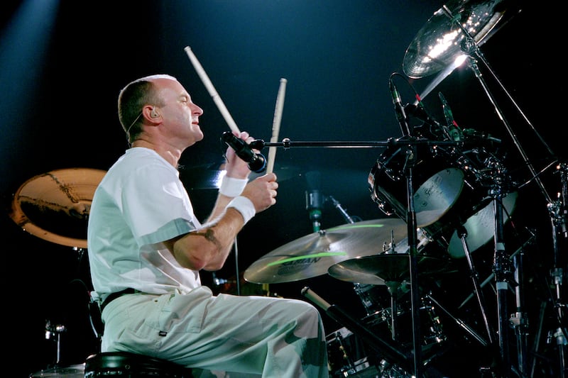 Phil Collins drumming during a performance on stage circa 1995