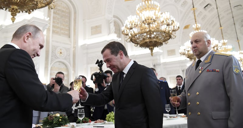 Russian President Vladimir Putin, Prime Minister Dmitry Medvedev and Colonel General Sergei Surovikin, commander of Russian forces in Syria, toast after a state awards ceremony for military personnel who served in Syria, at the Kremlin in Moscow, Russia December 28, 2017. REUTERS/Kirill Kudryavtsev/Pool