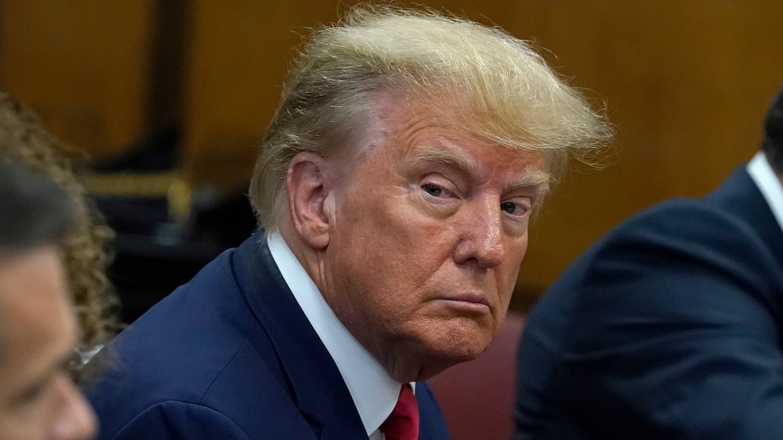 Former U.S. President Donald Trump sits with his attorneys inside the courtroom during his arraignment at the Manhattan Criminal Court April 4, 2023 in New York City.