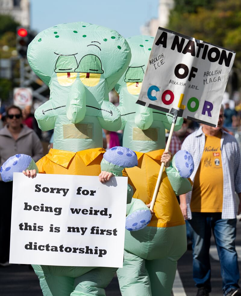 Protesters march down Pennsylvania Avenue NW for the second "No Kings" protest  in Washington on Saturday, October 18, 2025.
