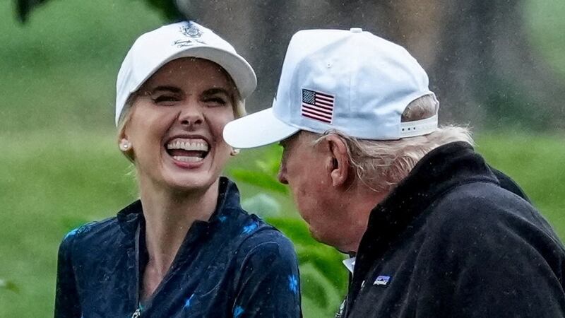 U.S. Interior Secretary Doug Burgum and Executive assistant to U.S. President Donald Trump Natalie Harp speak with Donald Trump during a visit at a golf course at Hains Point in Washington, D.C., U.S., June 28, 2026.