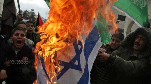 articles/2012/09/25/does-rejectionism-matter/palestinians-israeli-flag-openz_gov0wd