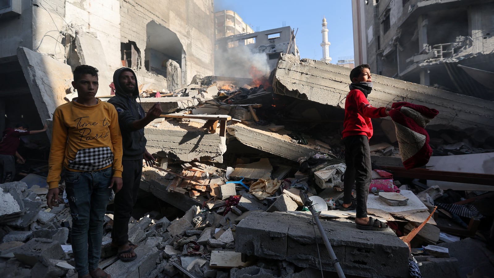 Palestinians inspect a house destroyed in an Israeli strike, amid the ongoing conflict between Israel and the Palestinian Islamist group Hamas, in Khan Younis, in the southern Gaza Strip, December 4, 2023.