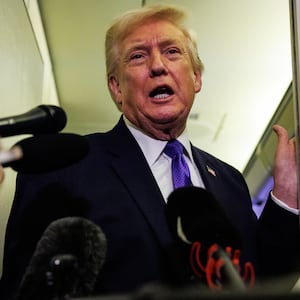 IN FLIGHT - FEBRUARY 06: U.S. President Donald Trump gaggles with reporters while aboard Air Force One on February 6, 2026 en route to Palm Beach, Florida. The President is spending the weekend at Mar-a-Lago, his private club. (Photo by Samuel Corum/Getty Images)