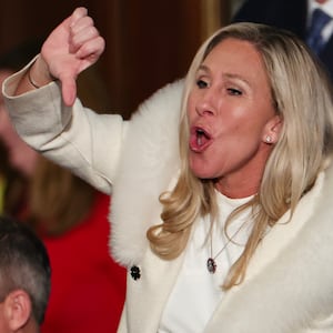 Marjorie Taylor Greene (R-GA) gives a thumbs down during President Joe Biden's State of the Union address.