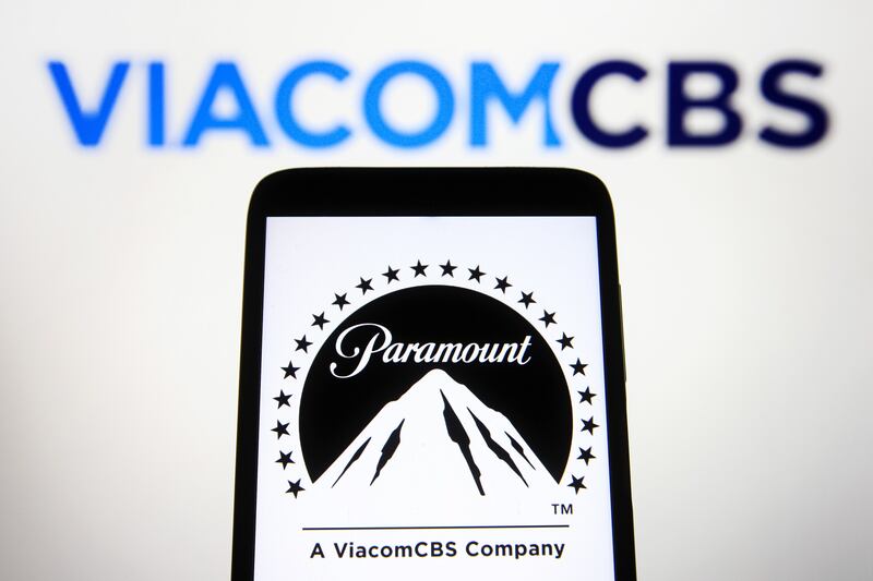 In this photo illustration, Paramount Pictures Corporation logo is seen on a smartphone screen with a ViacomCBS Inc. logo in the background.