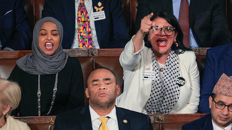 WASHINGTON, DC - FEBRUARY 24: Rep. Rashida Tlaib (D-MI) (R) and Rep. Ilhan Omar (D-MI) shout during U.S. President Donald Trump's State of the Union address during a Joint Session of Congress at the U.S. Capitol on February 24, 2026, in Washington, DC. Trump delivered his address days after the Supreme Court struck down the administration's tariff strategy and amid a U.S. military buildup in the Persian Gulf threatening Iran. (Photo by Chip Somodevilla/Getty Images)