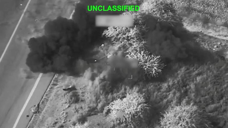 Smoke rises from a blast at an unknown location, during what the U.S. says are strikes on Iran.