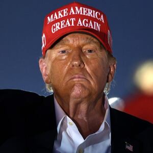 Donald Trump raises his fist as he looks on during the NASCAR Cup Series Coca-Cola 600 at Charlotte Motor Speedway on May 26, 2024.