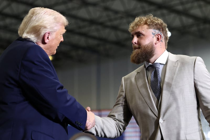 U.S. President Donald Trump and Jake Paul shake hands during a visit to Verst Logistics in Hebron, Kentucky, U.S., March 11, 2026.