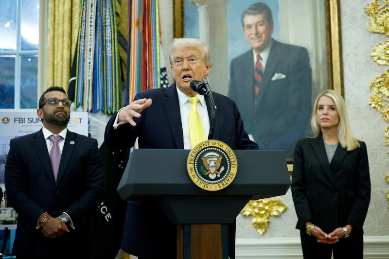 President Donald Trump speaks as Federal Bureau of Investigation Director Kash Patel (L) and U.S. Attorney General Pam Bondi look on