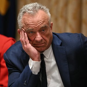 US Secretary of Health and Human Services Robert F. Kennedy Jr., look on as  President Donald Trump speaks during a Cabinet Meeting in the Cabinet Room of the White House in Washington, DC on December 2, 2025. (Photo by ANDREW CABALLERO-REYNOLDS / AFP via Getty Images)