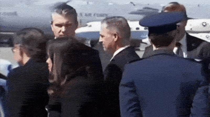 Defense Secretary Pete Hegseth chewing a mystery substance after landing in Delaware with President Donald Trump to attend the dignified transfer ceremony for six troops killed in the Iran War on March 18, 2026.