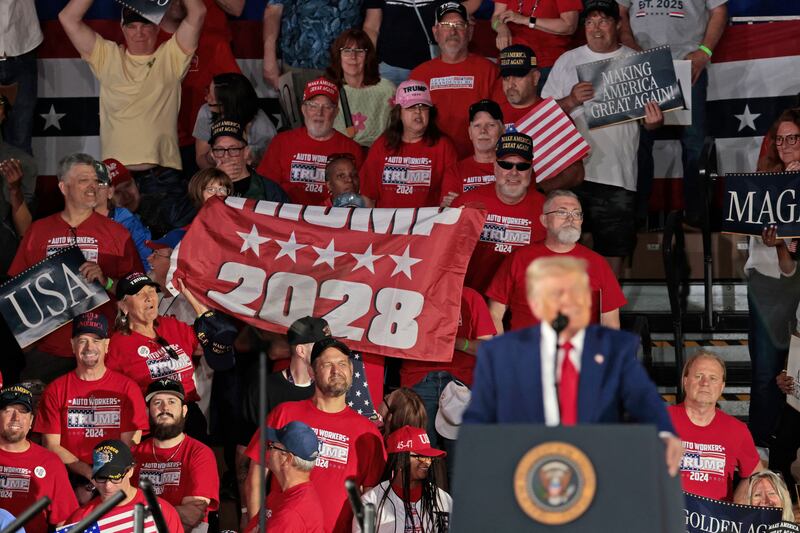 Auto Workers for Trumphold up a Trump 2028 banner as US President Donald Trump delivers his 100th Day in office achievement speech at Macomb County Community College Sports Expo Center in Warren, Michigan, on April 29, 2025. (Photo by JEFF KOWALSKY / AFP) (Photo by JEFF KOWALSKY/AFP via Getty Images)