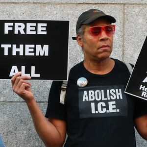 Protestors against Trump deportations holding giant banner