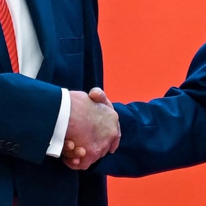 US President Donald Trump (R) shakes hands with China's President Xi Jinping at the Great Hall of the People in Beijing on May 14, 2026. (Photo by Kenny HOLSTON / POOL / AFP via Getty Images)