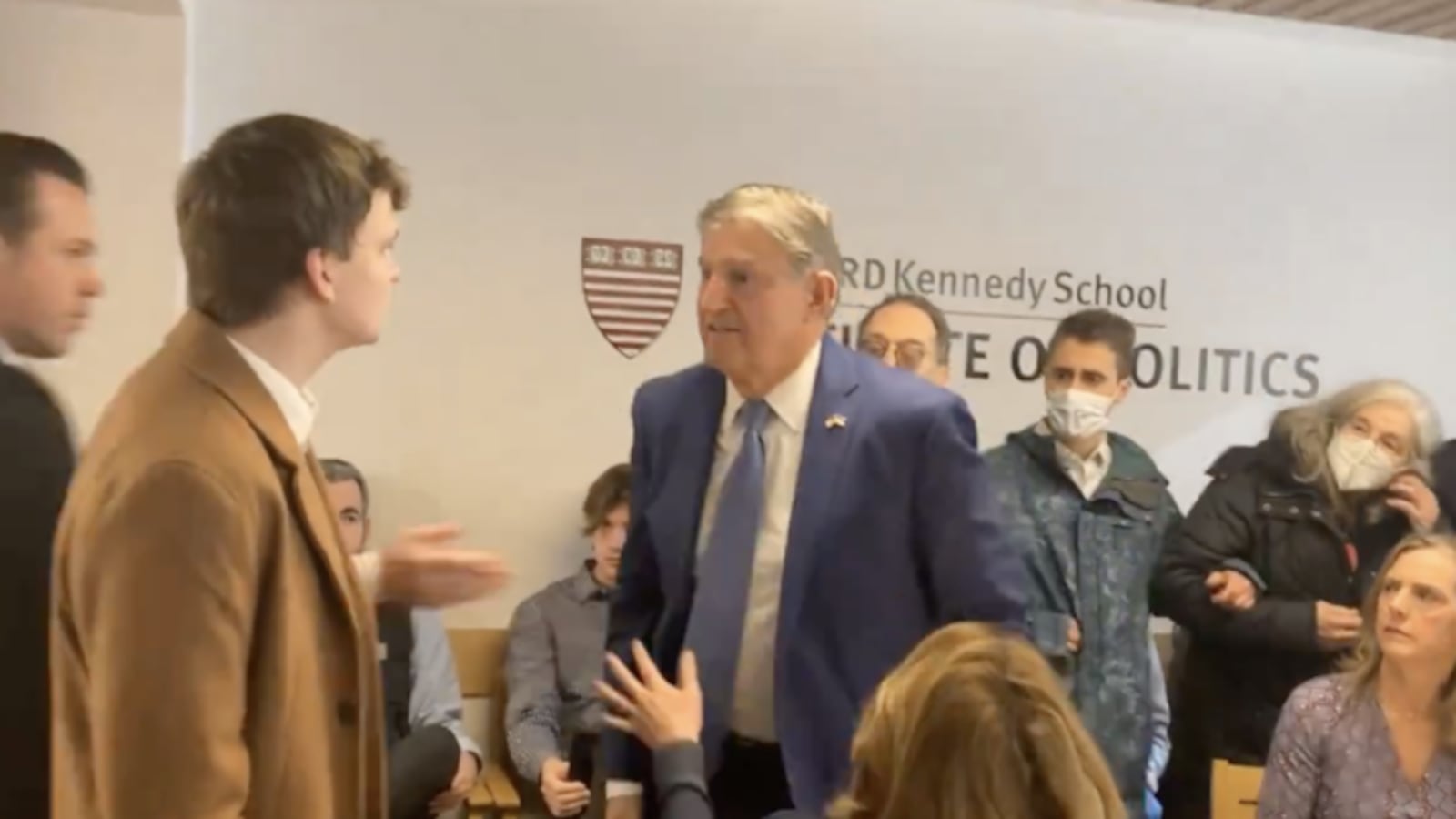 A climate protester confronts Sen. Joe Manchin.