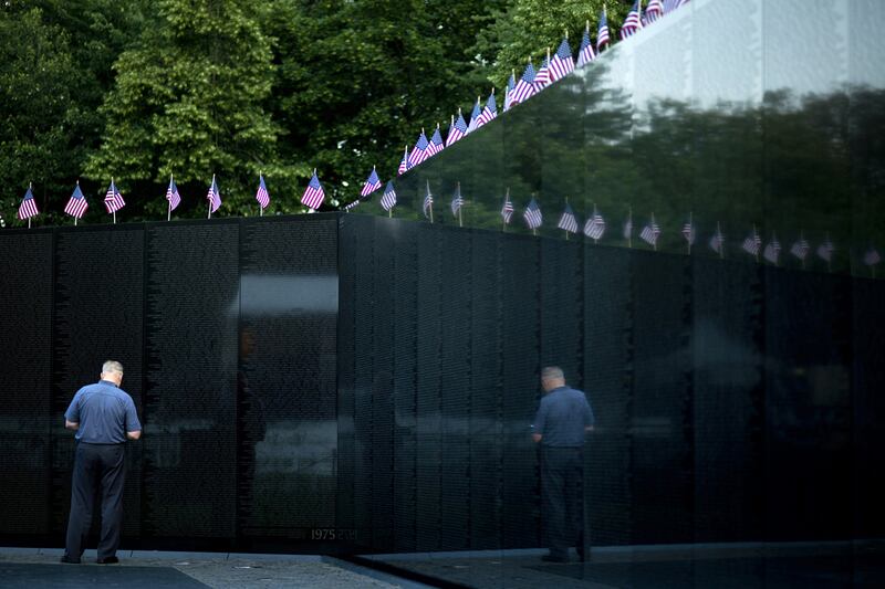 articles/2012/10/10/by-the-vietnam-wall-a-place-to-honor-our-post-9-11-service-members/911-memorial-the-vietnam-wall-scruggs-tease_n55phy