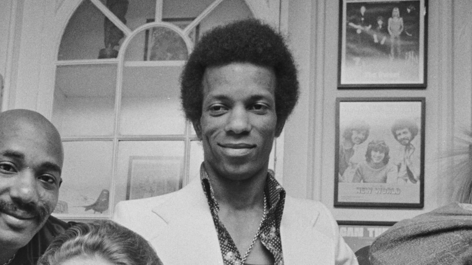 Hot Chocolate band members Larry Ferguson, Errol Brown, Tony Wilson and Patrick Olive pose with English romance novelist Jackie Collins on 7th June 1974, to receive silver discs for the sale of their single "Emma."