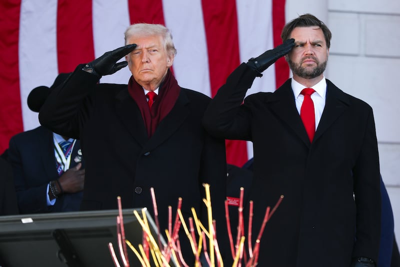 President Donald Trump and U.S. Vice President JD Vance salute during a ceremony at Memorial Amphitheater at Arlington National Cemetery to mark Veterans Day on November 11, 2025 in Arlington, Virginia.