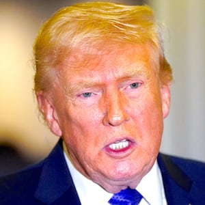 U.S. President Donald Trump speaks to reporters onboard Air Force One, on travel from West Palm Beach, Florida, to Joint Base Andrews, Maryland, U.S., February 16, 2026.