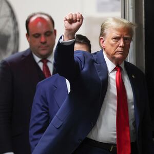 Former U.S. President Donald Trump gestures as he returns to court followed by his advisor Boris Epshteyn at Manhattan Criminal Court on May 16, 2024 in New York City.