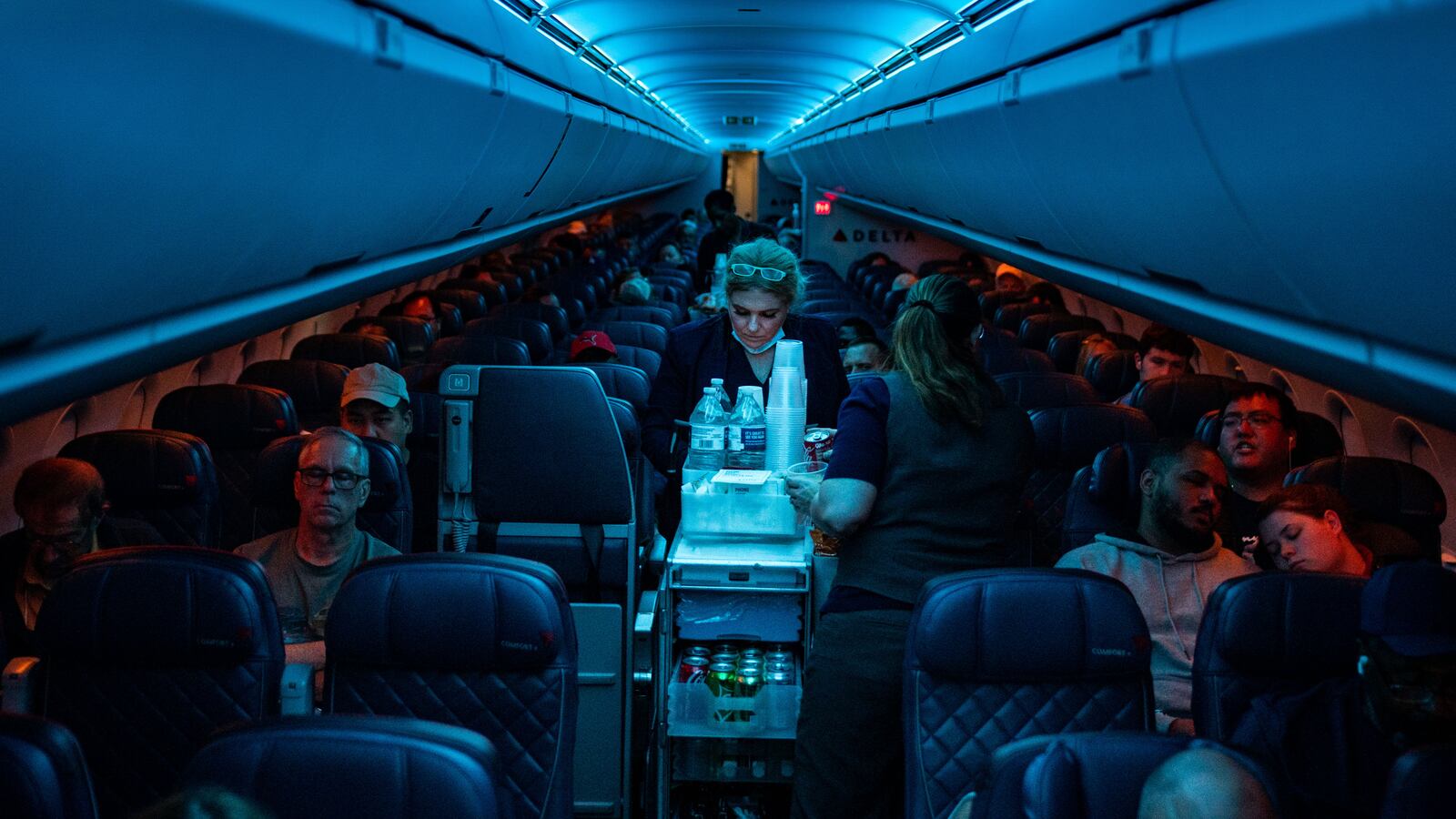 ATLANTA, GA - AUGUST 01: Flight attendants serve refreshments on a Delta Airlines flight from Hartsfield-Jackson International Airport on Monday, Aug. 1, 2022 in Atlanta, GA. (Kent Nishimura / Los Angeles Times via Getty Images)