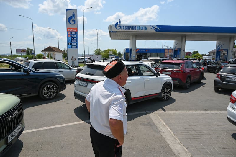 A Cossack watches to keep order and prevent conflicts in a queue at a petrol station due to fuel shortage following a spate of Ukrainian attacks on oil refineries, amid the Russia-Ukraine conflict, in the Russian Black Sea resort of Anapa, Russia, July 8, 2026.