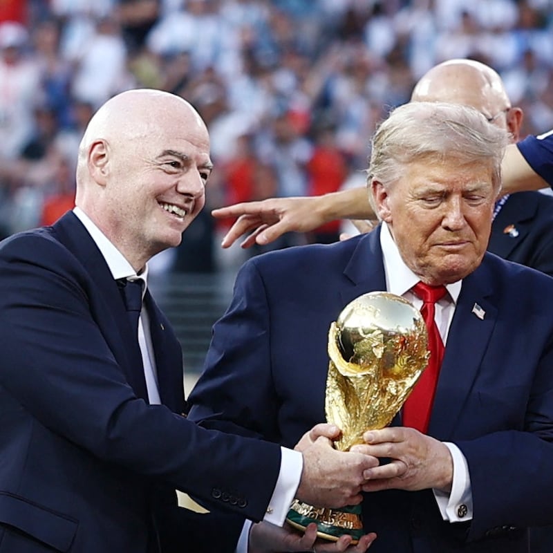 Gianni Infantino and Donald Trump both clutch the World Cup trophy this year.