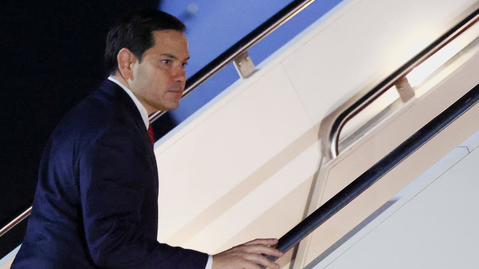 U.S. Secretary of State Marco Rubio boards a plane.