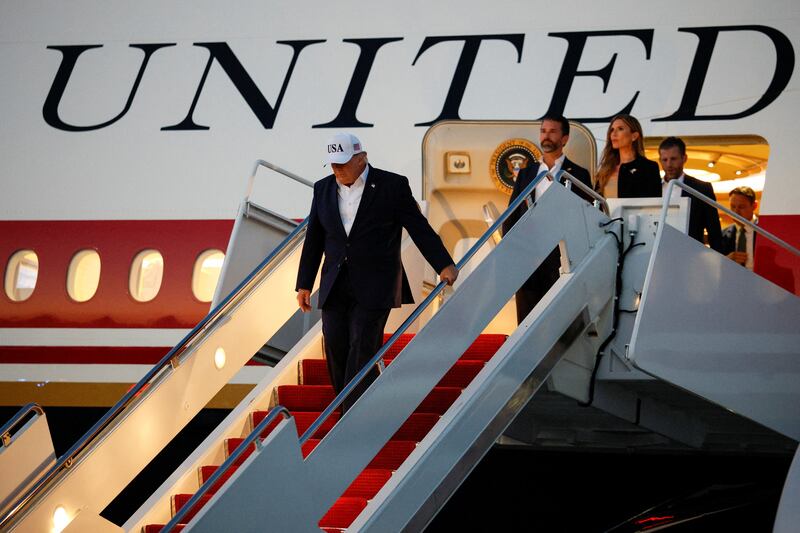 U.S. President Donald Trump, along with Donald Trump Jr. and Bettina Anderson, disembarks from the new Air Force One, a plane gifted by the Qatari government, after arriving at Joint Base Andrews, Maryland, U.S., July 1, 2026.