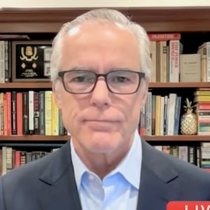 Split screen of Anderson Cooper interviewing Andrew McCabe.