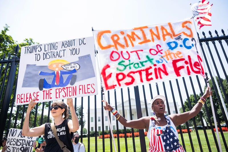 Demonstrators hold signs calling for the release of the Jeffrey Epstein files outside of the White House.