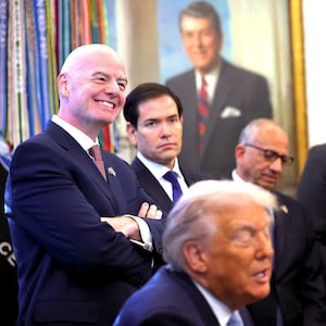 FIFA President Gianni Infantino (L) and U.S. Secretary of State Marco Rubio listen as U.S. President Donald Trump delivers remarks