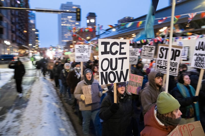 Demonstrators march during the nationwide "Stop ICE Terror" rally through downtown Minneapolis, Minnesota, on Jan. 20, 2026 in protest against US President Donald Trump's policies.