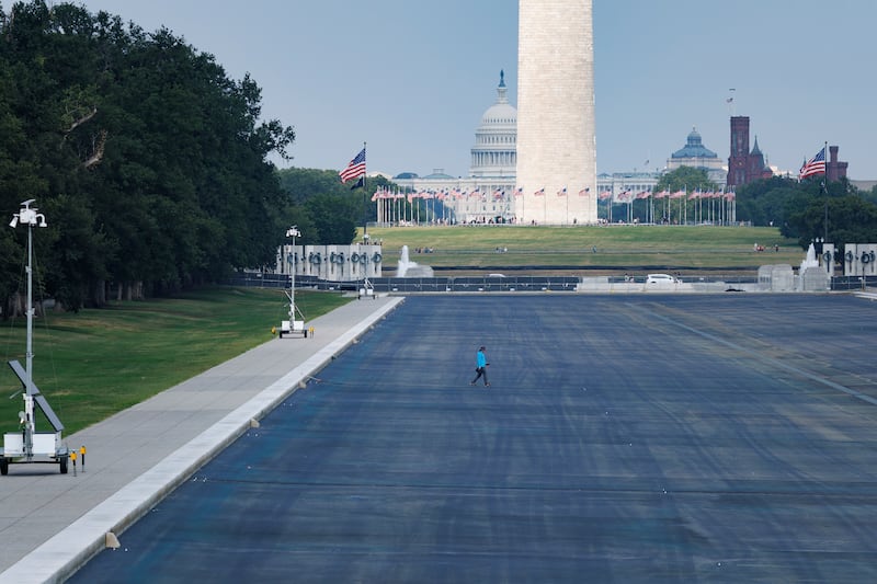 WASHINGTON, DC - JULY 20: A construction worker walks across an empty Reflecting Pool at the Lincoln Memorial on July 20, 2026 in Washington, DC. Trump ordered the pool to be drained for repairs, after the project faced a series of setbacks, including alleged vandalism. (Photo by Tom Brenner/Getty Images)