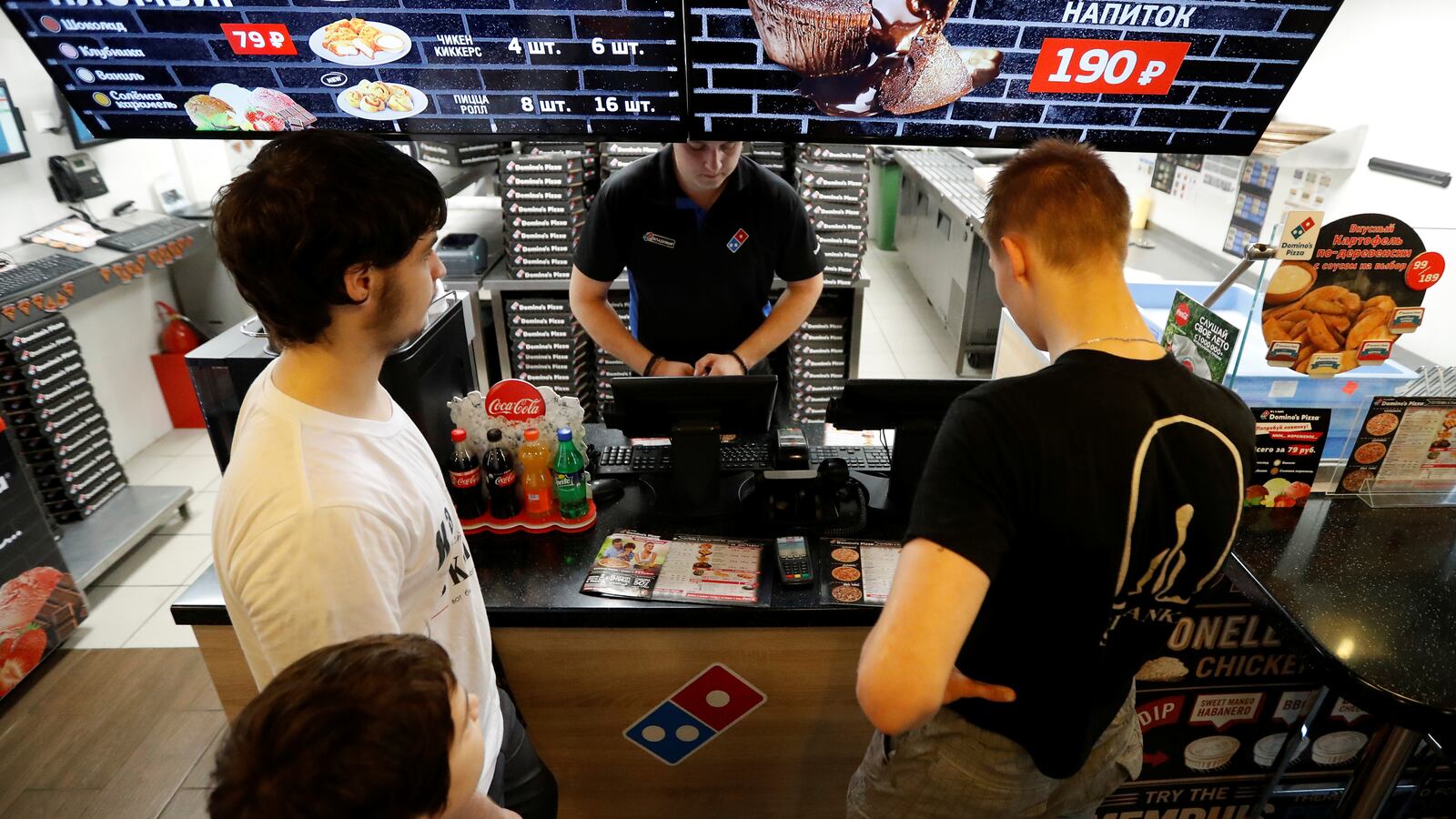 Customers make an order at a Domino’s Pizza restaurant in Moscow, Russia, July 14, 2017.