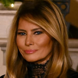 US First Lady Melania Trump looks on as President Donald Trump delivers remarks during the Congressional Ball in the Grand Foyer of the White House in Washington, DC, on December 11, 2025.