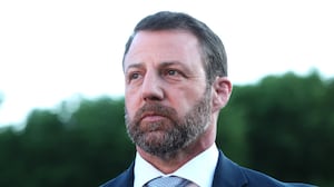 U.S. Secretary of Homeland Security Markwayne Mullin looks on as U.S. President Donald Trump speaks