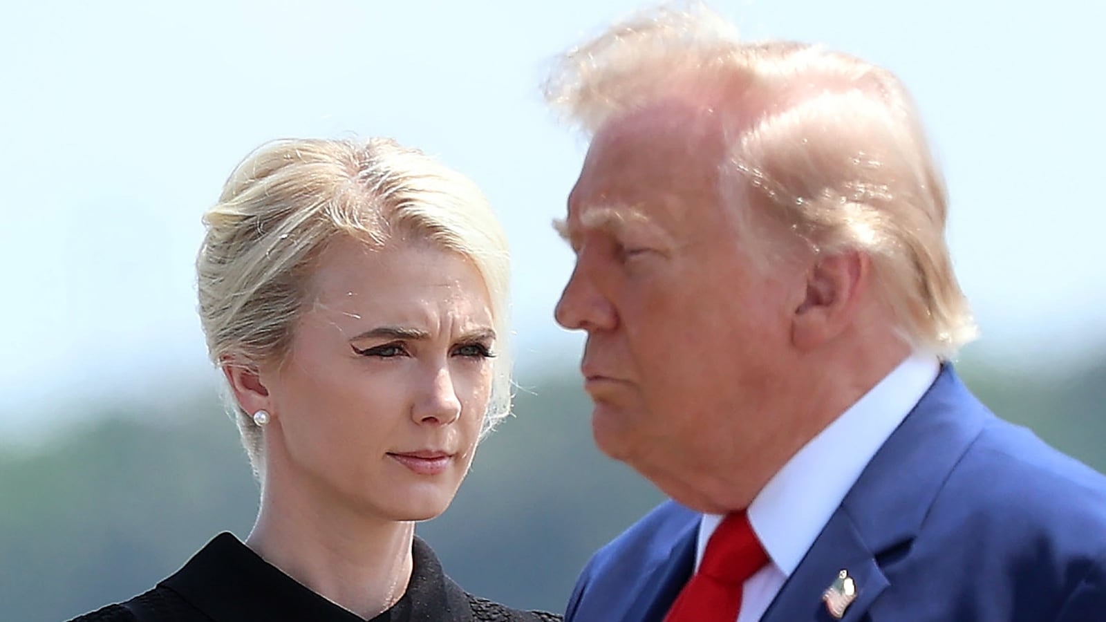 DOVER, DELAWARE - JULY 22: Natalie Harp, executive assistant to U.S. President Donald Trump, stands as President Trump arrives for a dignified transfer at Dover Air Force Base for military casualties of the war with Iran on July 22, 2026 in Dover, Delaware. Trump attend the dignified transfer of of Army 1st Lt. Tyler James Feehan, Staff Sgt. Michael Emmanuel Swinton, Army Sgt. Angel S. Rampersad and Army Pvt. Isabella Gonzales. (Photo by Kevin Dietsch/Getty Images)