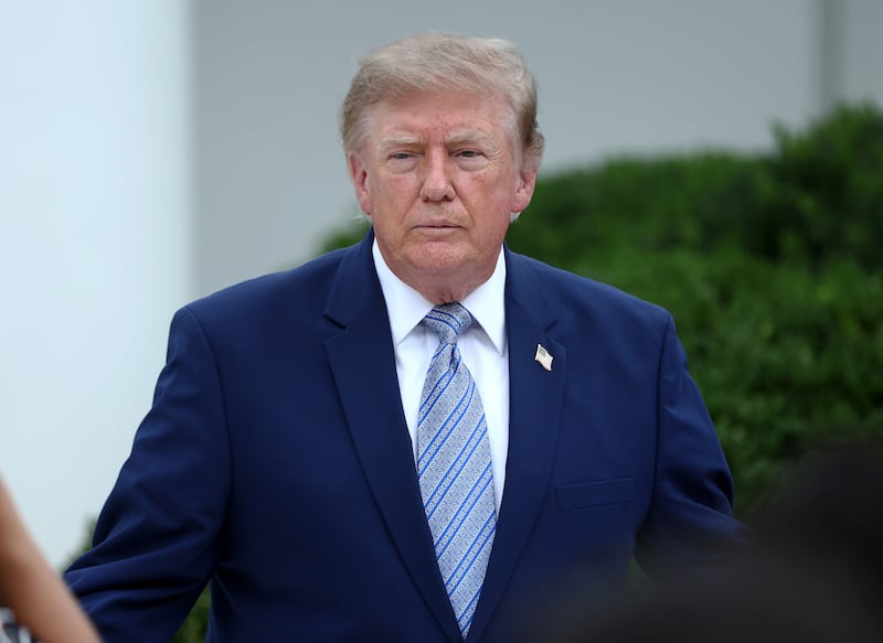 WASHINGTON, DC - AUGUST 20: U.S. President Donald Trump (C) speaks with guests during an event announcing the expansion of a foster care initiative in the Rose Garden of the White House on August 20, 2026 in Washington, DC. The event focused on the first lady's “Foster the Future” initiative, with plans to expand opportunities for individuals transitioning from foster care. (Photo by Finn Gomez/Getty Images)