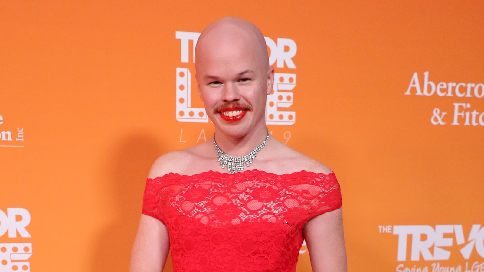 Sam Brinton in a red dress.