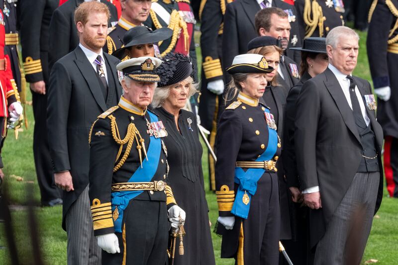 LONDON, ENGLAND - SEPTEMBER 19:  Britain's King Charles III, Camilla, Queen Consort, Princess Anne, Princess Royal, Prince Andrew, Duke of York, Princess Beatrice, Princess Eugenie, Peter Phillips, Prince Harry, Duke of Sussex, Meghan, Duchess of Sussex, watch as the coffin of the late Queen Elizabeth II arrives at Wellington Arch from Westminster Abbey on September 19, 2022 in London, England. Elizabeth Alexandra Mary Windsor was born in Bruton Street, Mayfair, London on 21 April 1926. She married Prince Philip in 1947 and ascended the throne of the United Kingdom and Commonwealth on 6 February 1952 after the death of her Father, King George VI. The Queen will be laid to rest at St George's Chapel, Windsor beside her husband Prince Philip, Duke of Edinburgh and her parents King George VI and The Queen Mother. Queen Elizabeth II died at Balmoral Castle in Scotland on September 8, 2022, and is succeeded by her eldest son, King Charles III. (Photo by Bryn Colton/Getty Images)