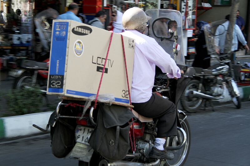 articles/2013/10/17/don-t-offer-sanctions-relief-to-iran/OZ_Tehran_motorbike_bo0fh9