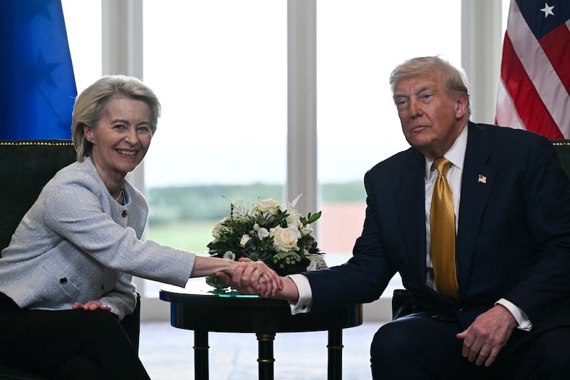President Donald Trump shook hands with European Commission President Ursula von der Leyen last July after agreeing on a trade deal between the two economies following their meeting, in Turnberry, Scotland on July 27, 2025, but progress on implementing the deal has been slow.